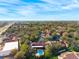 Aerial view of the neighborhood featuring a community pool, lush landscaping, and well-maintained buildings at 7650 Forest Trl # 7, Port Richey, FL 34668