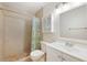 Bathroom featuring neutral tile, a shower, a vanity, and a stylish mirror at 7650 Forest Trl # 7, Port Richey, FL 34668