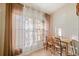 Bright dining area with a table and chairs, illuminated by natural light through sheer curtains at 7650 Forest Trl # 7, Port Richey, FL 34668