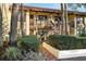 Inviting exterior featuring stone accents, a brown stairway, vibrant plants and a red brick pathway at 7650 Forest Trl # 7, Port Richey, FL 34668