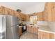Well-lit kitchen featuring stainless steel refrigerator and lots of storage at 7650 Forest Trl # 7, Port Richey, FL 34668
