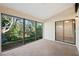 Enclosed lanai providing a serene view of the lush backyard at 7650 Forest Trl # 7, Port Richey, FL 34668