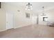 Open living room featuring vaulted ceilings, a chair and a view into the kitchen at 7650 Forest Trl # 7, Port Richey, FL 34668
