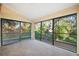 This cozy sunroom is encased with window screens allowing for beautiful wooded view from inside at 7650 Forest Trl # 7, Port Richey, FL 34668