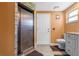 Contemporary bathroom featuring a walk-in shower with stone and modern fixtures at 8017 Shepherd Ave, Spring Hill, FL 34606