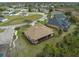 Aerial view of home featuring a screened lanai, lush landscaping, and well-manicured lawn at 8373 Maybelle Dr, Weeki Wachee, FL 34613