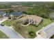 Aerial view of the house, showcasing its layout, landscaped yard and beautiful pond nearby at 8373 Maybelle Dr, Weeki Wachee, FL 34613