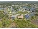 High aerial showing several homes in neighborhood with lake in the distance at 8373 Maybelle Dr, Weeki Wachee, FL 34613