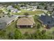 Aerial view of the property showcasing landscaping, well-manicured lawn, and surrounding neighborhood at 8373 Maybelle Dr, Weeki Wachee, FL 34613