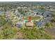Beautiful aerial view of a suburban neighborhood with lush greenery and a tranquil lake at 8373 Maybelle Dr, Weeki Wachee, FL 34613