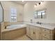 Bathroom features a large soaking tub, vanity with ample storage, and natural light at 8373 Maybelle Dr, Weeki Wachee, FL 34613