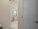 Bathroom entrance with vanity on the left and glass-enclosed shower at 8373 Maybelle Dr, Weeki Wachee, FL 34613