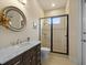 Bright bathroom features a dark vanity with a vessel sink and a tiled walk-in shower at 8373 Maybelle Dr, Weeki Wachee, FL 34613