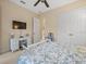 Cozy bedroom featuring light walls, carpet and a flat screen television on the wall at 8373 Maybelle Dr, Weeki Wachee, FL 34613