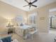 Bright bedroom features a ceiling fan, window with shutters, and stylish decor at 8373 Maybelle Dr, Weeki Wachee, FL 34613