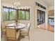 Cozy breakfast nook boasts natural light, and an adjacent covered lanai creates a seamless indoor-outdoor living experience at 8373 Maybelle Dr, Weeki Wachee, FL 34613