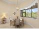 Charming breakfast nook with large window, stylish chandelier, and cozy seating at 8373 Maybelle Dr, Weeki Wachee, FL 34613