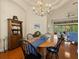 Elegant dining room features a chandelier, wood table, and a hutch for a cozy yet sophisticated entertaining space at 8373 Maybelle Dr, Weeki Wachee, FL 34613