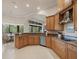 Kitchen with granite countertops, wooden cabinets, stainless steel appliances, and breakfast nook at 8373 Maybelle Dr, Weeki Wachee, FL 34613