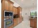 Kitchen featuring wooden cabinetry and stainless steel microwave and oven at 8373 Maybelle Dr, Weeki Wachee, FL 34613