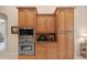 Kitchen with stainless steel microwave, oven and wooden cabinetry at 8373 Maybelle Dr, Weeki Wachee, FL 34613