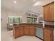 Kitchen features wooden cabinets, granite countertops, stainless steel appliances and a breakfast nook with a view at 8373 Maybelle Dr, Weeki Wachee, FL 34613