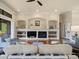 Inviting living room showcases a fireplace, custom built-ins, and comfortable seating, perfect for relaxation at 8373 Maybelle Dr, Weeki Wachee, FL 34613