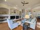 Well-lit living room with a fireplace, custom built-ins, and seamless transition to a dining area at 8373 Maybelle Dr, Weeki Wachee, FL 34613