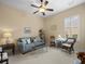 Cozy living room with comfortable furniture and a ceiling fan at 8373 Maybelle Dr, Weeki Wachee, FL 34613
