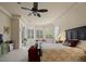 A serene main bedroom with natural light, carpeted flooring, and a cozy sitting area at 8373 Maybelle Dr, Weeki Wachee, FL 34613