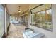 Spacious screened patio with brick flooring, comfortable seating, and sliding glass doors at 8373 Maybelle Dr, Weeki Wachee, FL 34613
