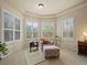 Comfortable sitting area featuring an armchair, ottoman, and an abundance of natural light from large windows at 8373 Maybelle Dr, Weeki Wachee, FL 34613