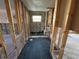 Bathroom renovation showcasing dark tile flooring, exposed studs, and a new shower space at 8607 Longboat Ln, Hudson, FL 34667