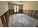 Spacious bedroom showcasing a blank canvas for renovation with natural light from two windows at 8607 Longboat Ln, Hudson, FL 34667