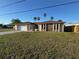 Charming single-story home with modern exterior, well-maintained lawn, and palm trees at 8607 Longboat Ln, Hudson, FL 34667