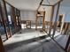 Open-concept living room and garage renovation, highlighting exposed studs and concrete flooring at 8607 Longboat Ln, Hudson, FL 34667