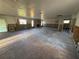 Open living room with a brick fireplace, exposed framing and natural light, ready for renovation at 8607 Longboat Ln, Hudson, FL 34667