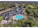 Aerial view of community, highlighting the clubhouse, pool, and tennis courts at 9634 Green Needle Dr, New Port Richey, FL 34655