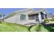 Low angle view of the rear patio with brick pavers, screened in porch, and well manicured lawn at 9634 Green Needle Dr, New Port Richey, FL 34655