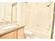 Bright bathroom with granite countertops, tub and shower combination, and wooden vanity at 9634 Green Needle Dr, New Port Richey, FL 34655