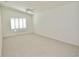 Large, bright bedroom with neutral carpet, vaulted ceilings and white plantation shutters at 9634 Green Needle Dr, New Port Richey, FL 34655