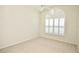 Cozy bedroom with neutral carpet, white walls, and unique, arched window at 9634 Green Needle Dr, New Port Richey, FL 34655