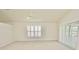 Bright bedroom with neutral carpet, white walls, vaulted ceilings and plantation shutters at 9634 Green Needle Dr, New Port Richey, FL 34655