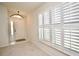 Bright foyer featuring neutral carpet, plantation shutters, and an entry door with sidelight at 9634 Green Needle Dr, New Port Richey, FL 34655