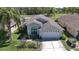 Charming single-story home featuring a manicured lawn and attached two-car garage at 9634 Green Needle Dr, New Port Richey, FL 34655