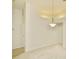 Open living area with plush carpeting, fresh white paint, and a modern light fixture at 9634 Green Needle Dr, New Port Richey, FL 34655