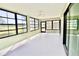 Bright sunroom features tile flooring, ceiling fan, and large windows for natural light at 9634 Green Needle Dr, New Port Richey, FL 34655