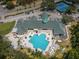 Aerial view of community featuring a pool, tennis courts, parking, lush greenery, and clubhouse at 9713 Sweeping View Dr, New Port Richey, FL 34655
