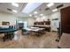 Well-lit break room with multiple tables, chairs, kitchen amenities, and tile flooring at 9713 Sweeping View Dr, New Port Richey, FL 34655