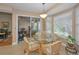 Bright breakfast nook features sliding glass doors and backyard views at 9713 Sweeping View Dr, New Port Richey, FL 34655